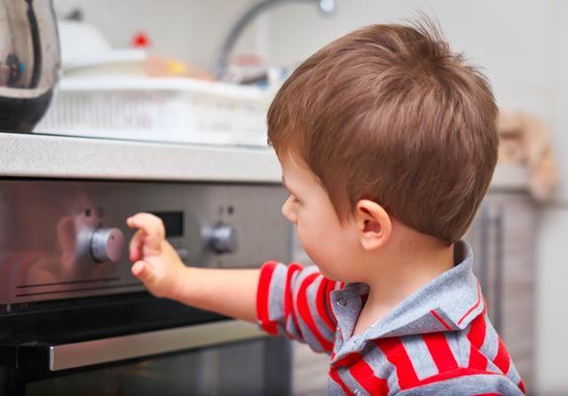 Child in front of oven