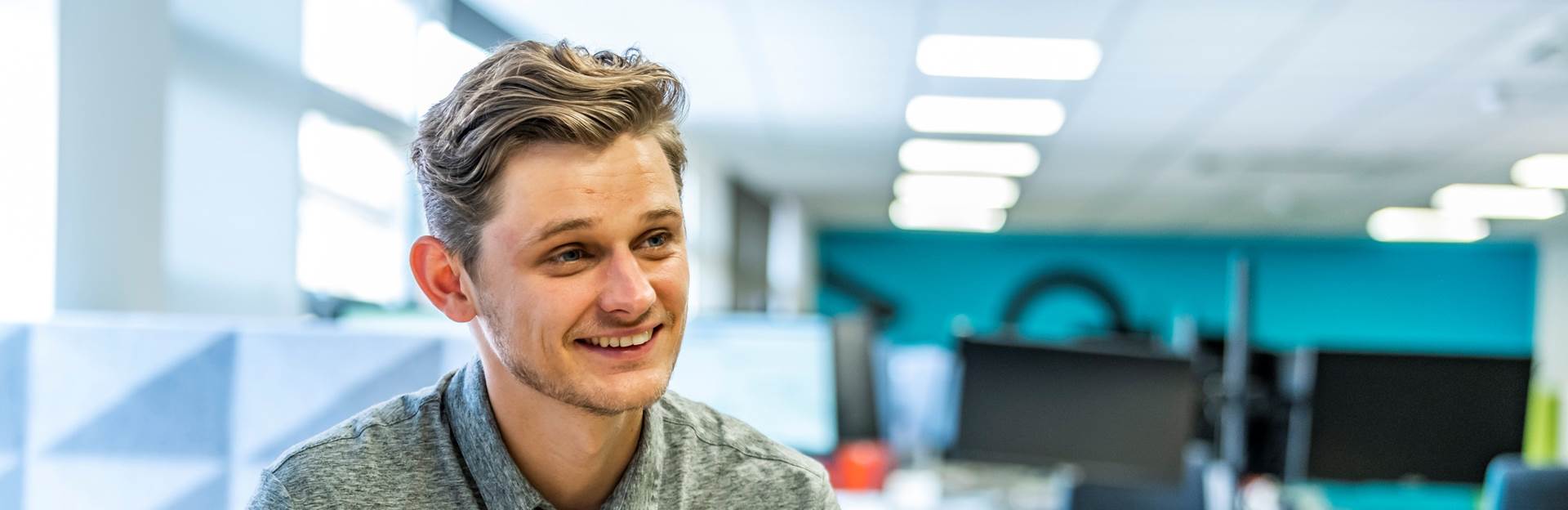 Staff member sat at desk in the office