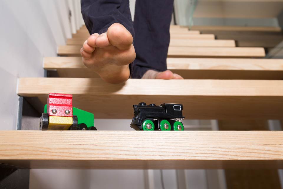 Person walking down stairs with toys on