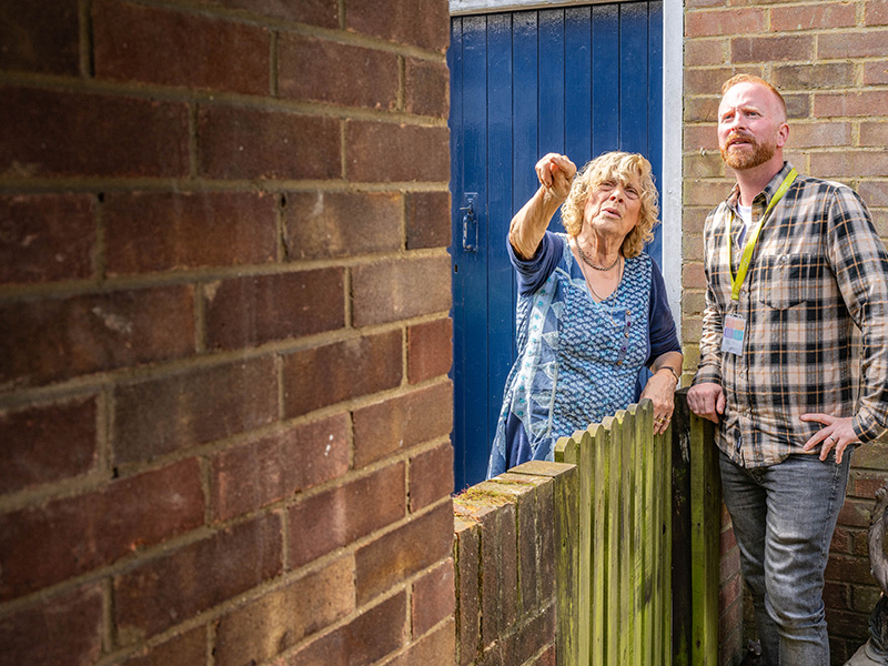 Housing officer and woman talking