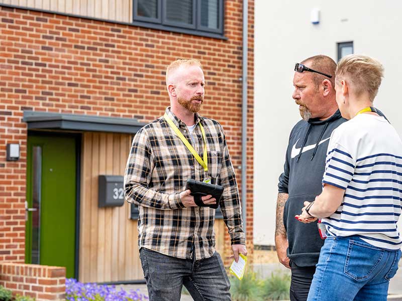 Housing officers and customer outside