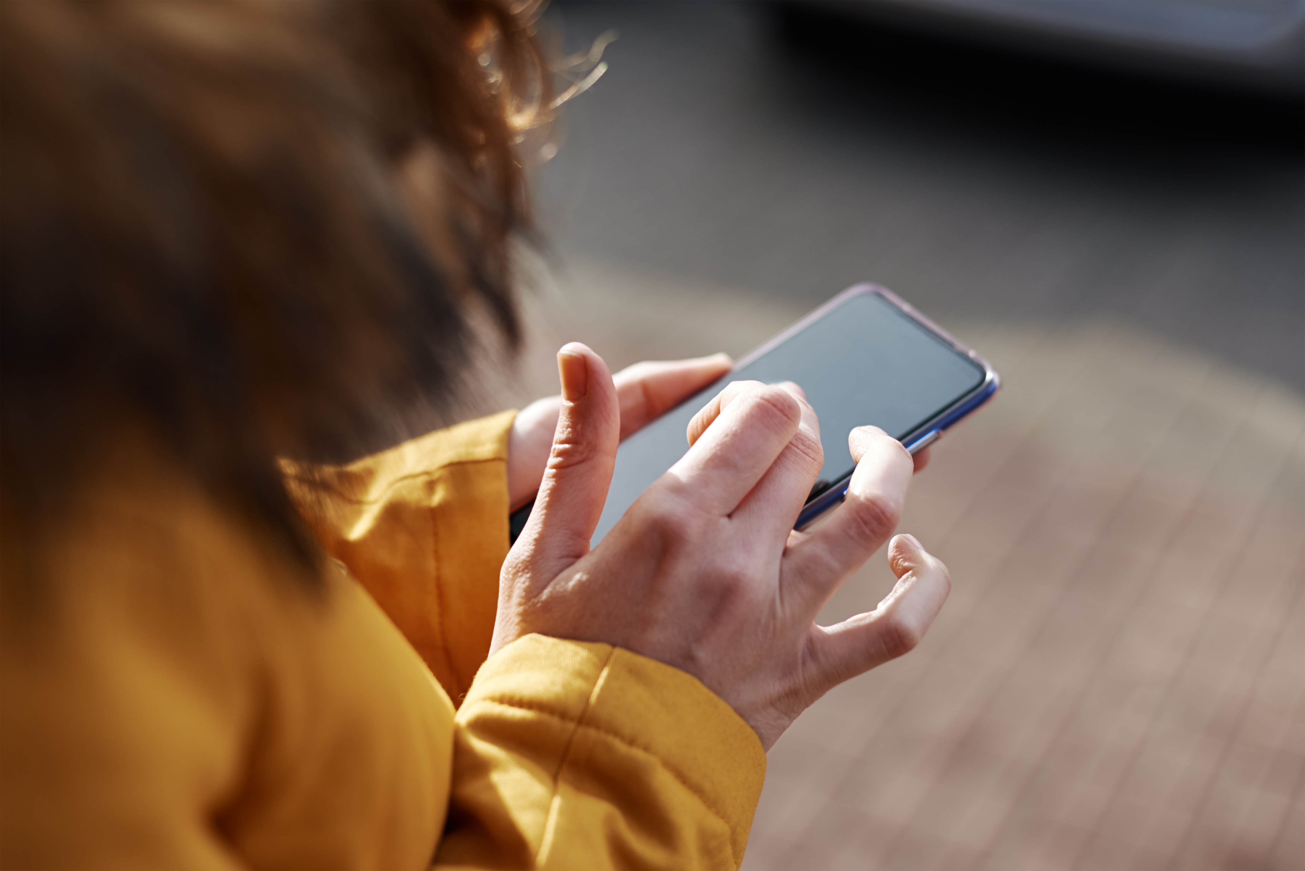 Woman sending message on her mobile phone