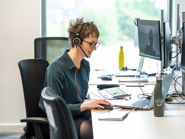 Person in call centre on computer