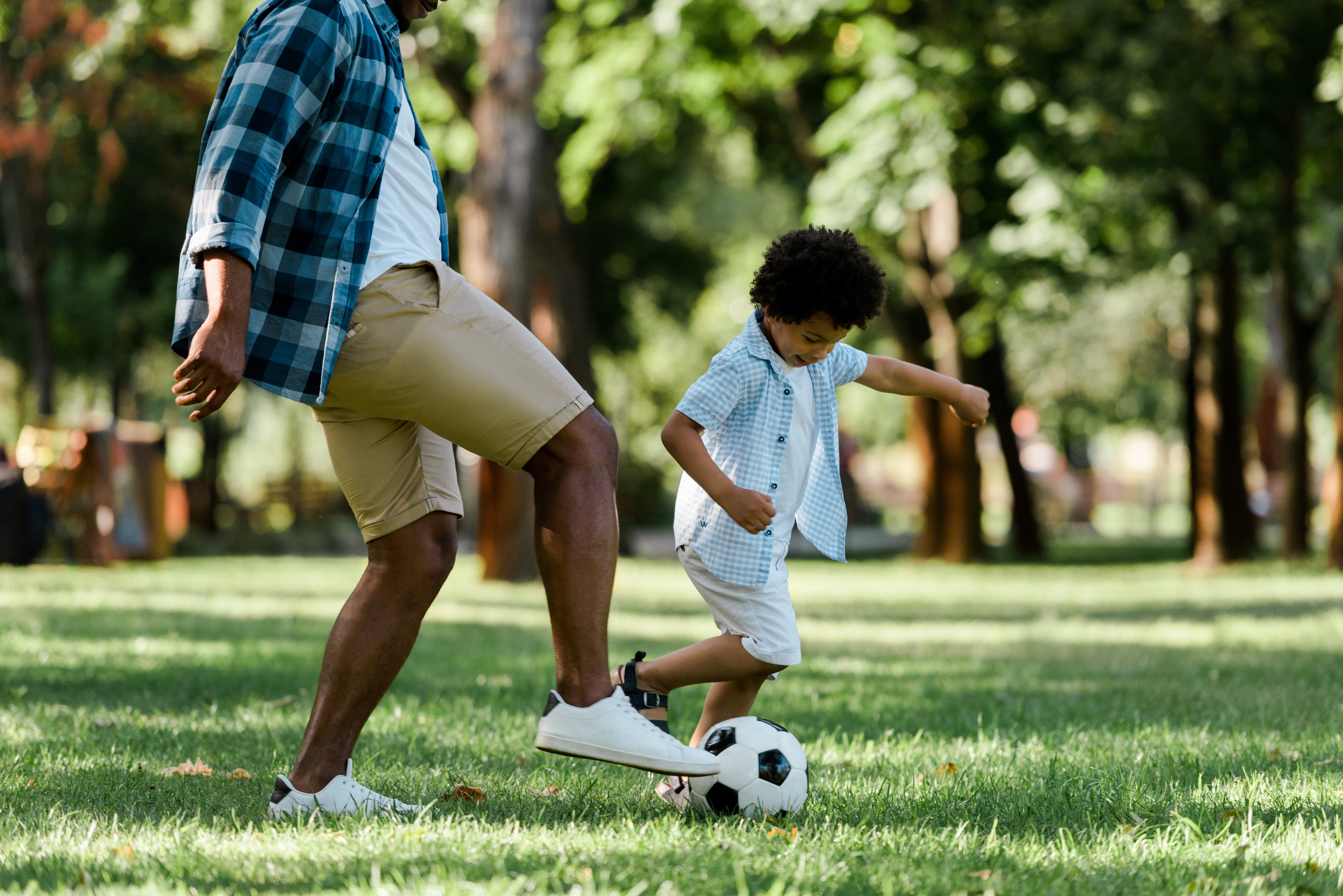 father and son playing football