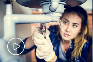 Image of woman fixing a broken sink with white play button icon overlaying